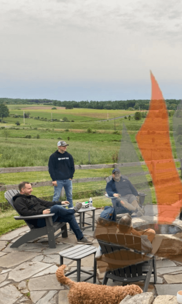 group of business builders near a fire with logo overlay.